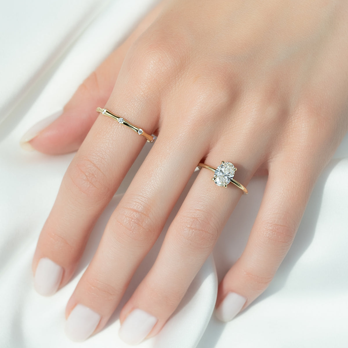 Oval cut CVD diamond hidden halo engagement ring with delicate band in white gold