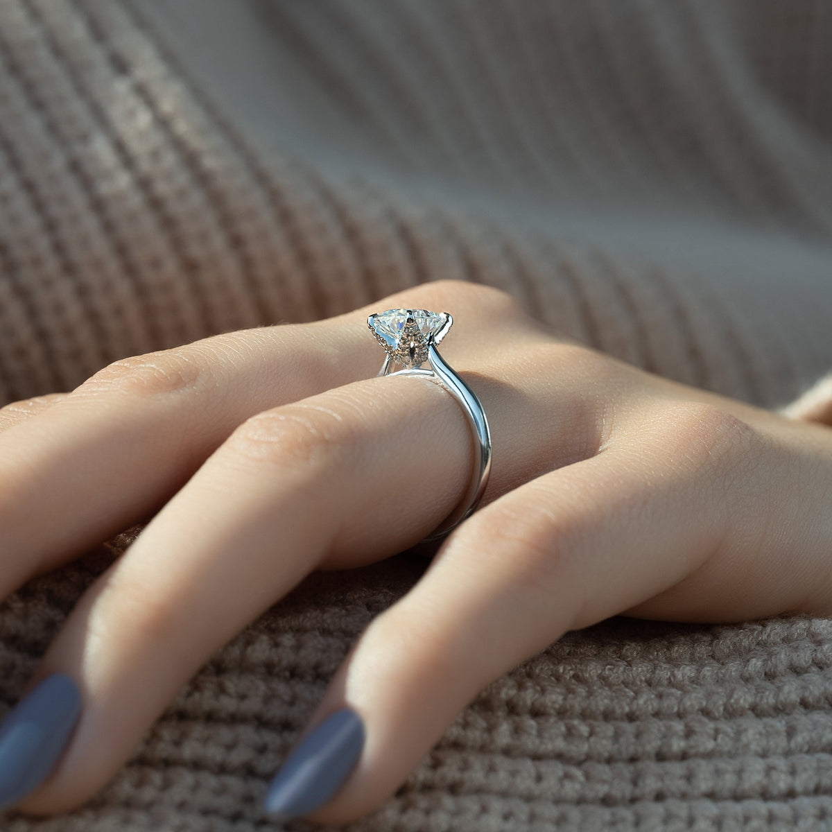Oval cut moissanite solitaire engagement ring in platinum setting