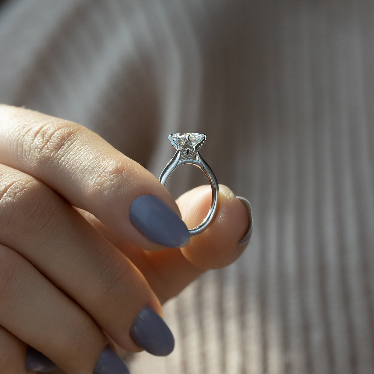 Oval cut moissanite solitaire engagement ring in platinum setting