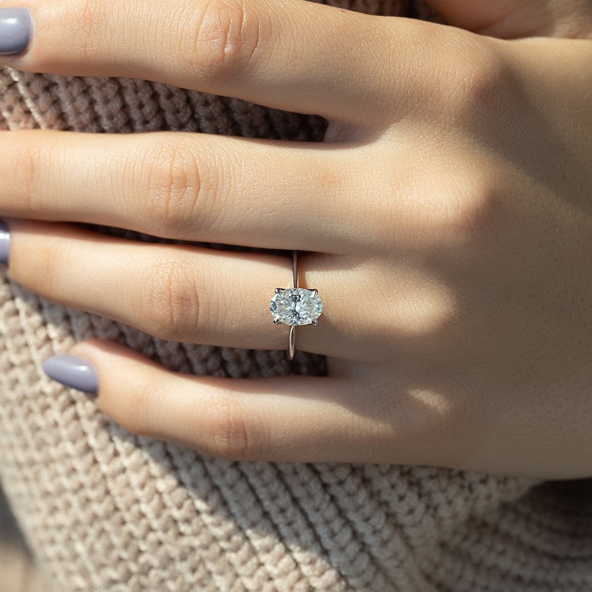 Oval cut moissanite solitaire engagement ring in platinum setting