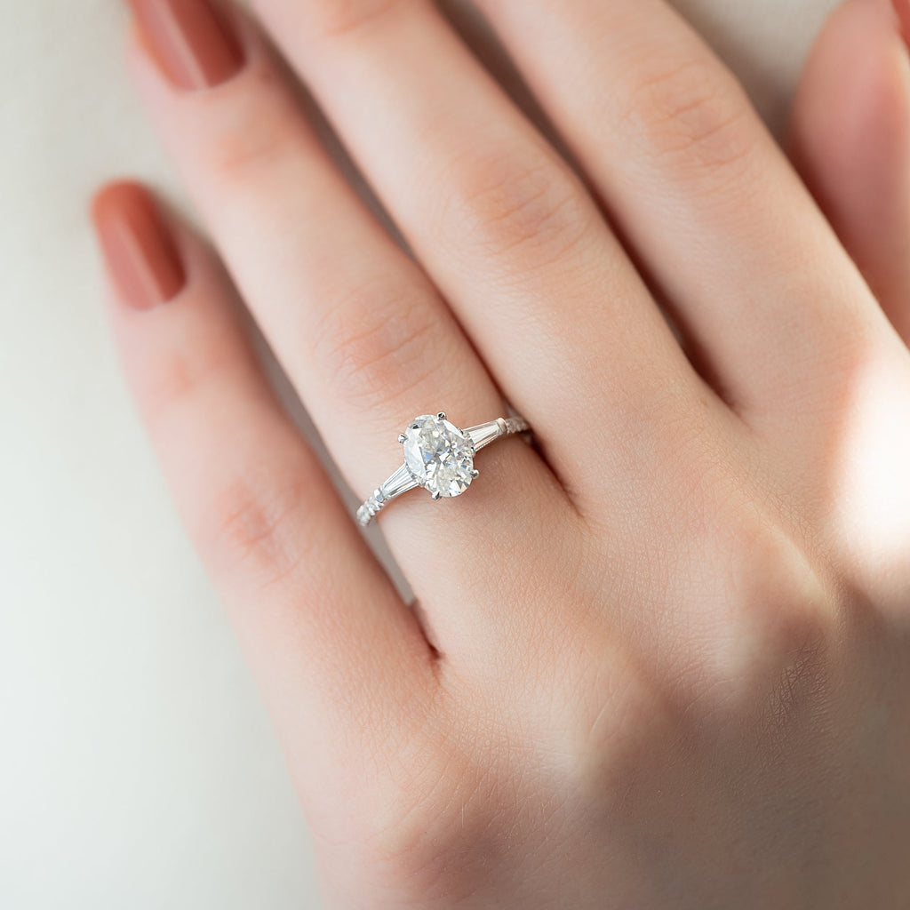 Oval cut CVD diamond three stone engagement ring with side stones in white gold