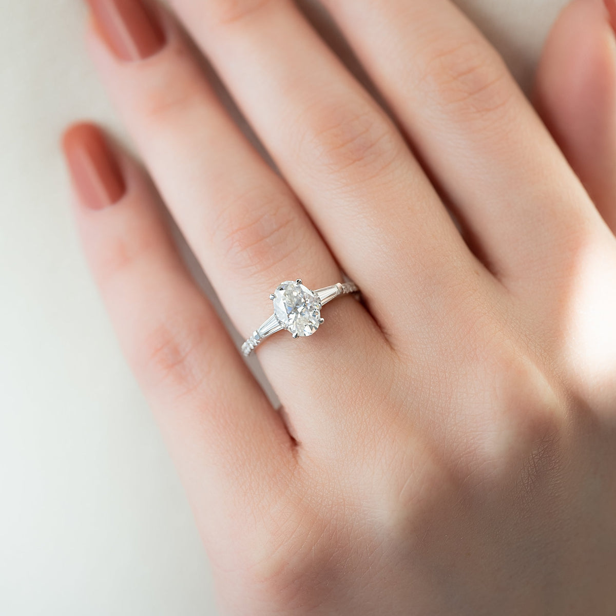 Oval cut CVD diamond three stone engagement ring with side stones in white gold