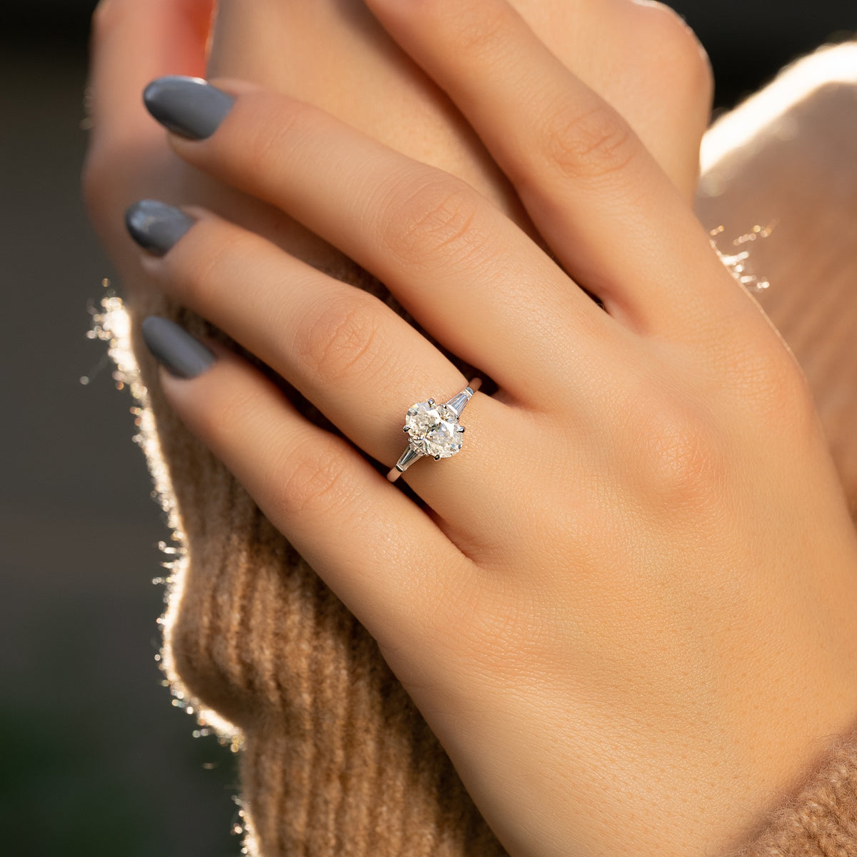 Oval cut CVD diamond three-stone engagement ring in white gold setting