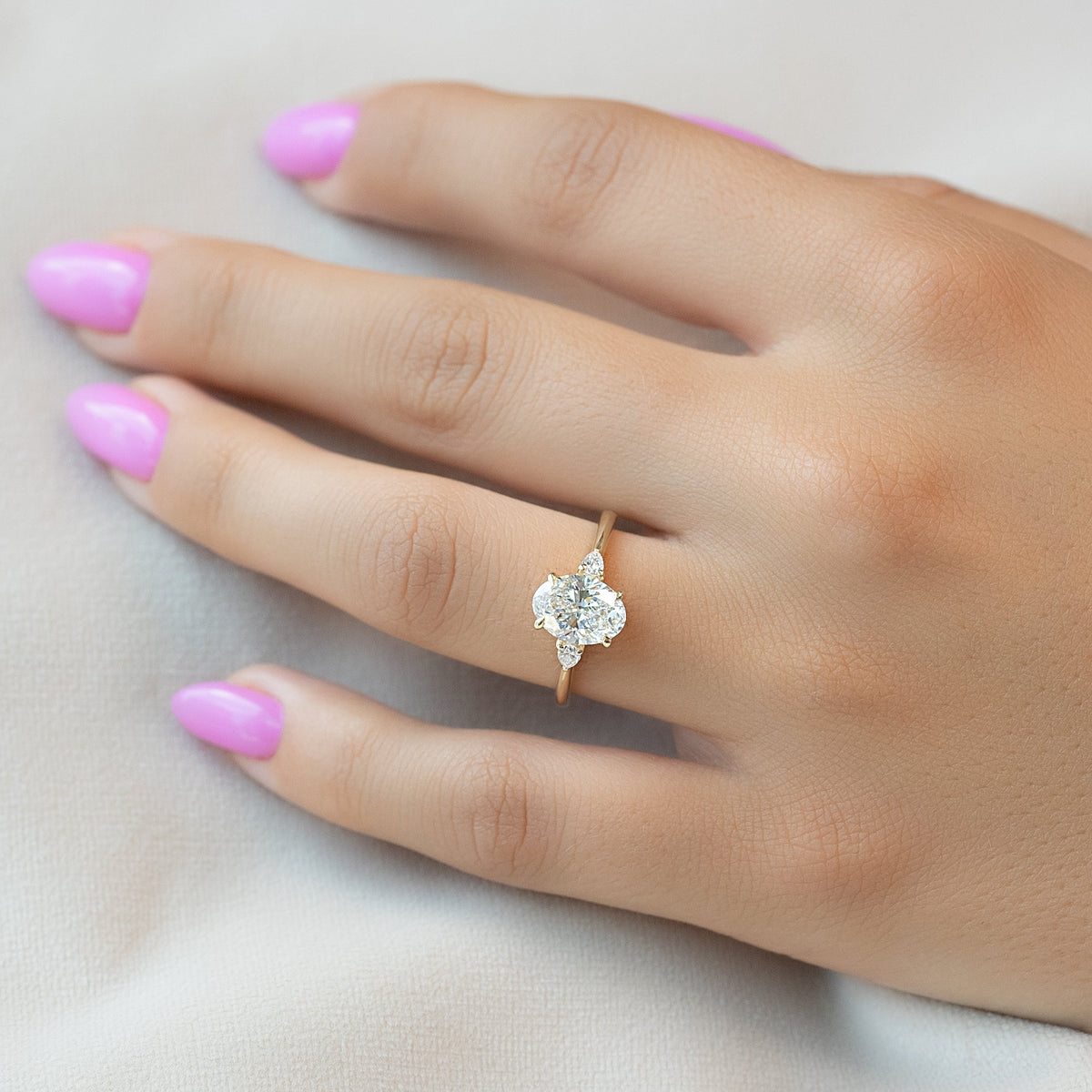 Oval cut CVD diamond three stone style engagement ring in platinum setting