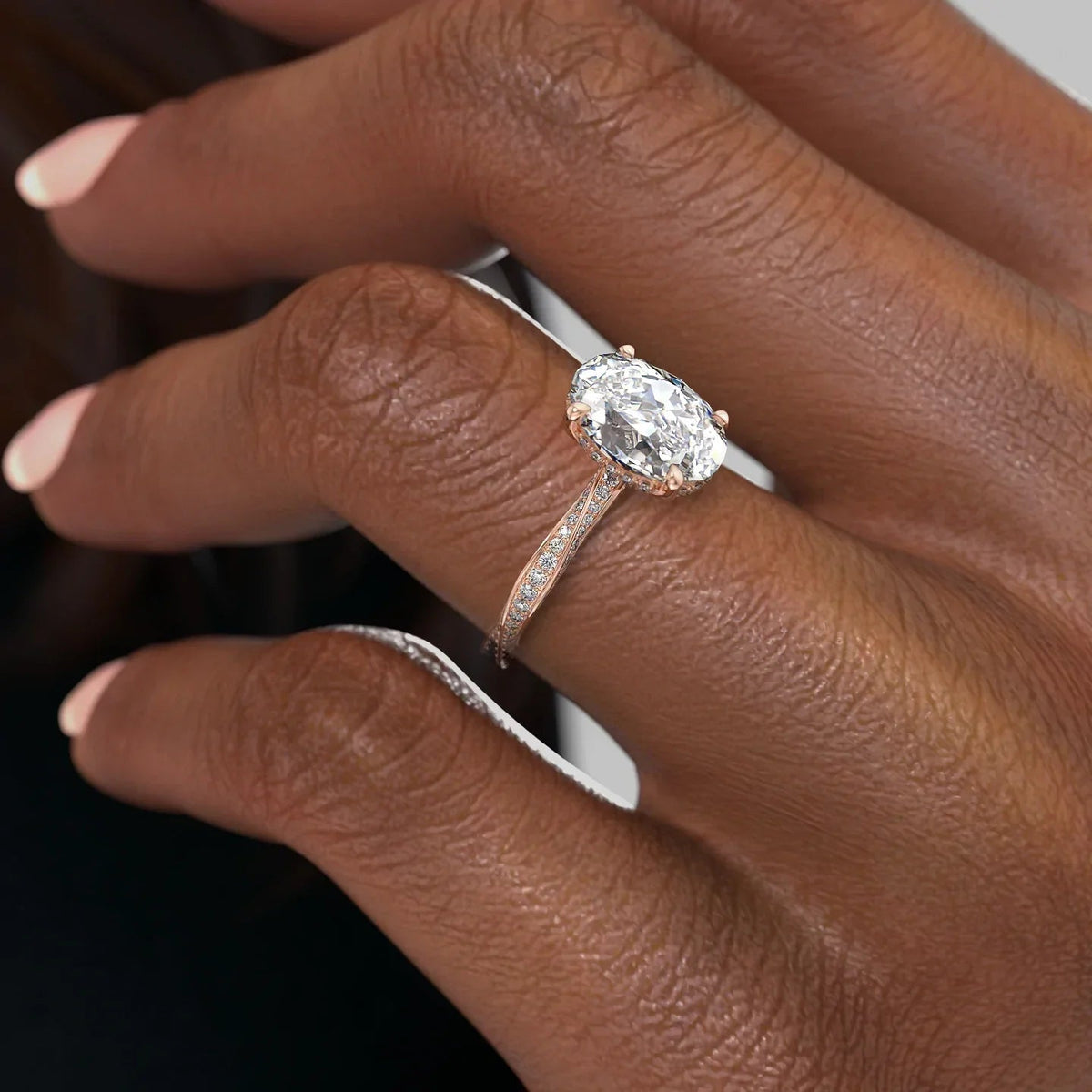 Oval cut CVD diamond engagement ring with twisted band and hidden halo setting
