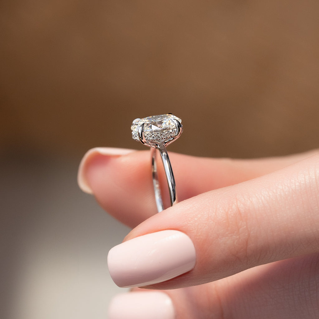 Oval cut CVD diamond hidden halo engagement ring with delicate band in white gold