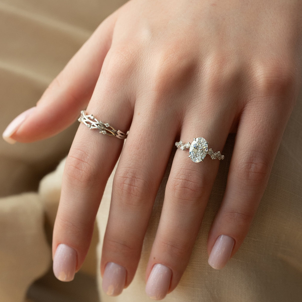 Oval cut CVD diamond engagement ring with hidden halo and pave diamond band in white gold