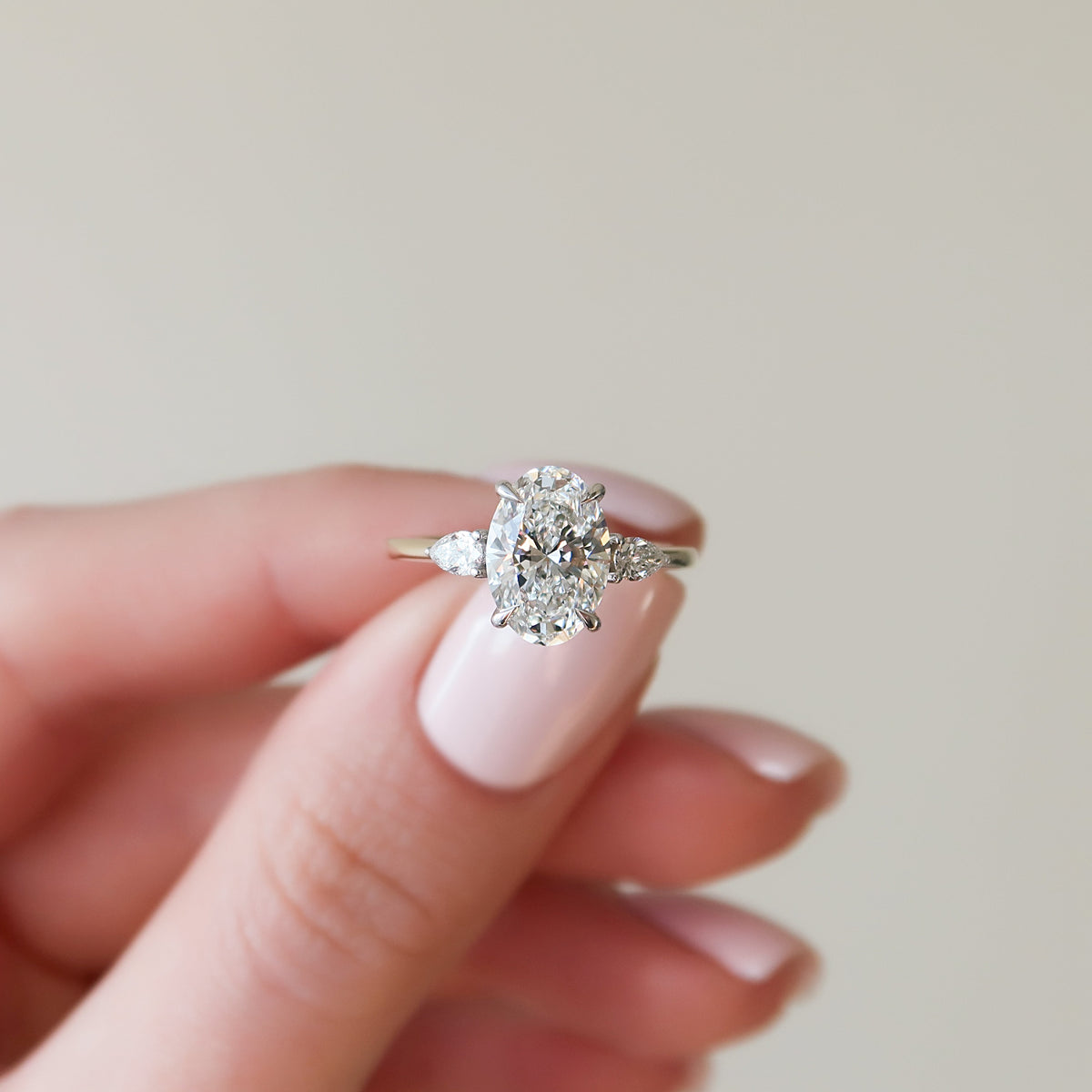 Oval cut CVD diamond three stone style engagement ring in platinum setting