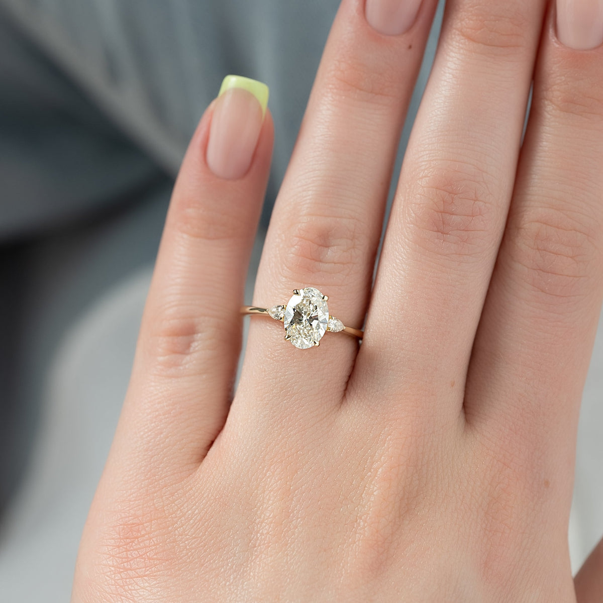 Oval cut CVD diamond three stone style engagement ring in platinum setting