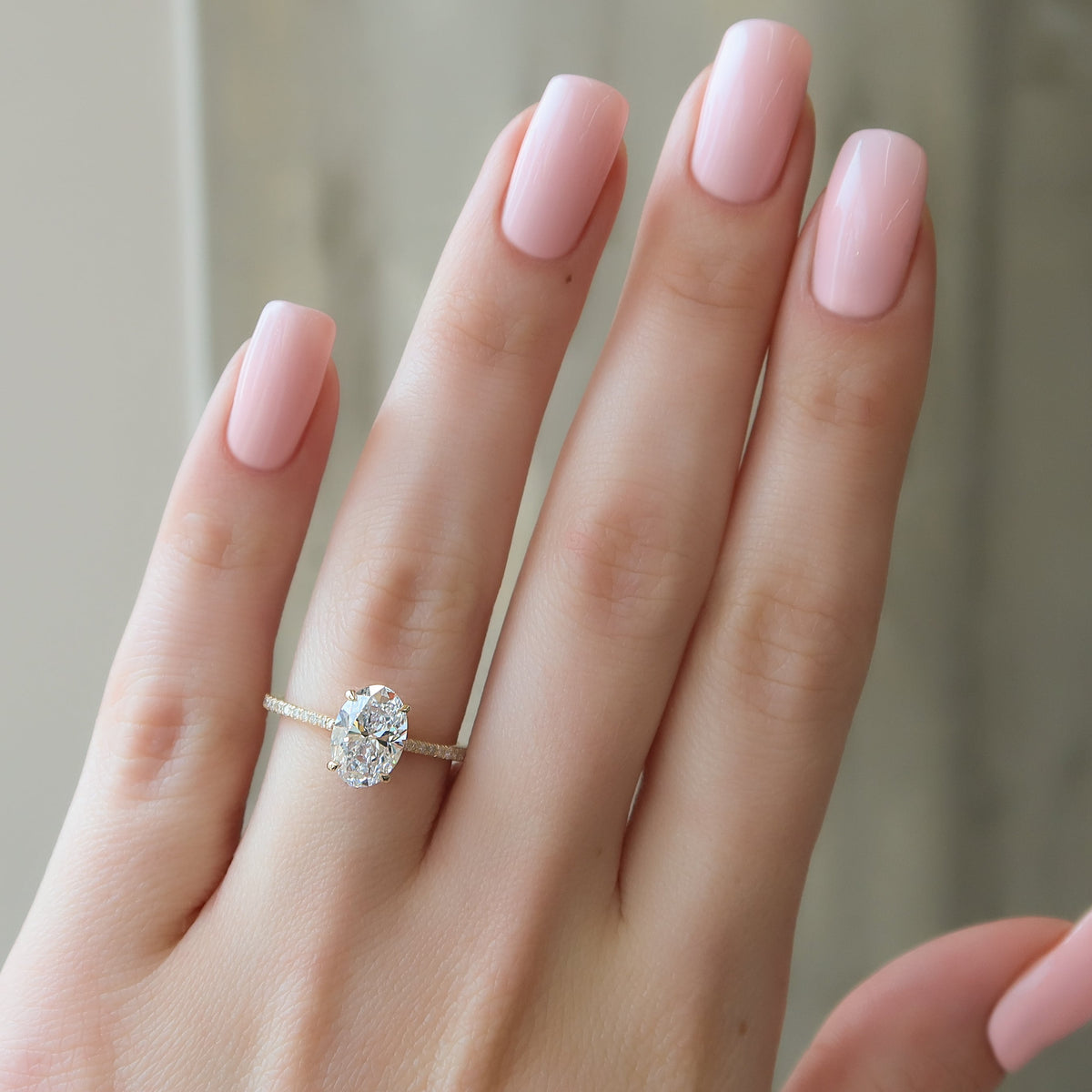 Oval cut CVD diamond engagement ring with pave diamond band in platinum setting