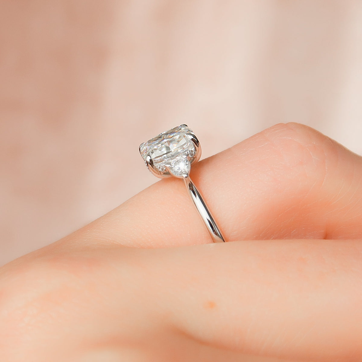 Elongated cushion cut CVD diamond three stone engagement ring in white gold