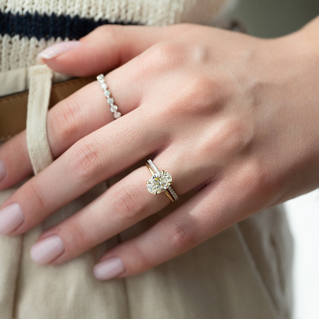 Oval cut CVD diamond hidden halo engagement ring with delicate band in white gold
