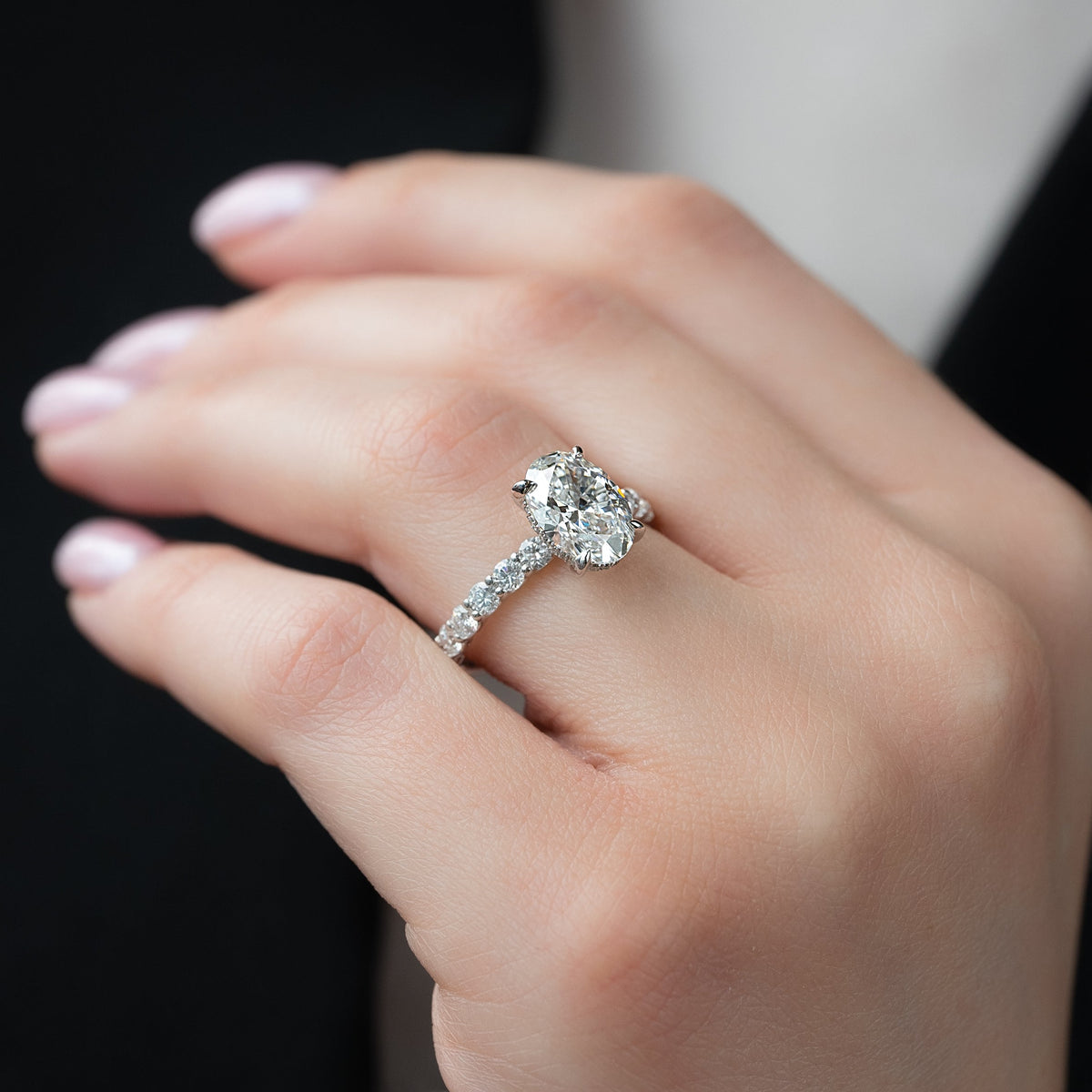 Oval cut CVD diamond hidden halo engagement ring with pave band in white gold