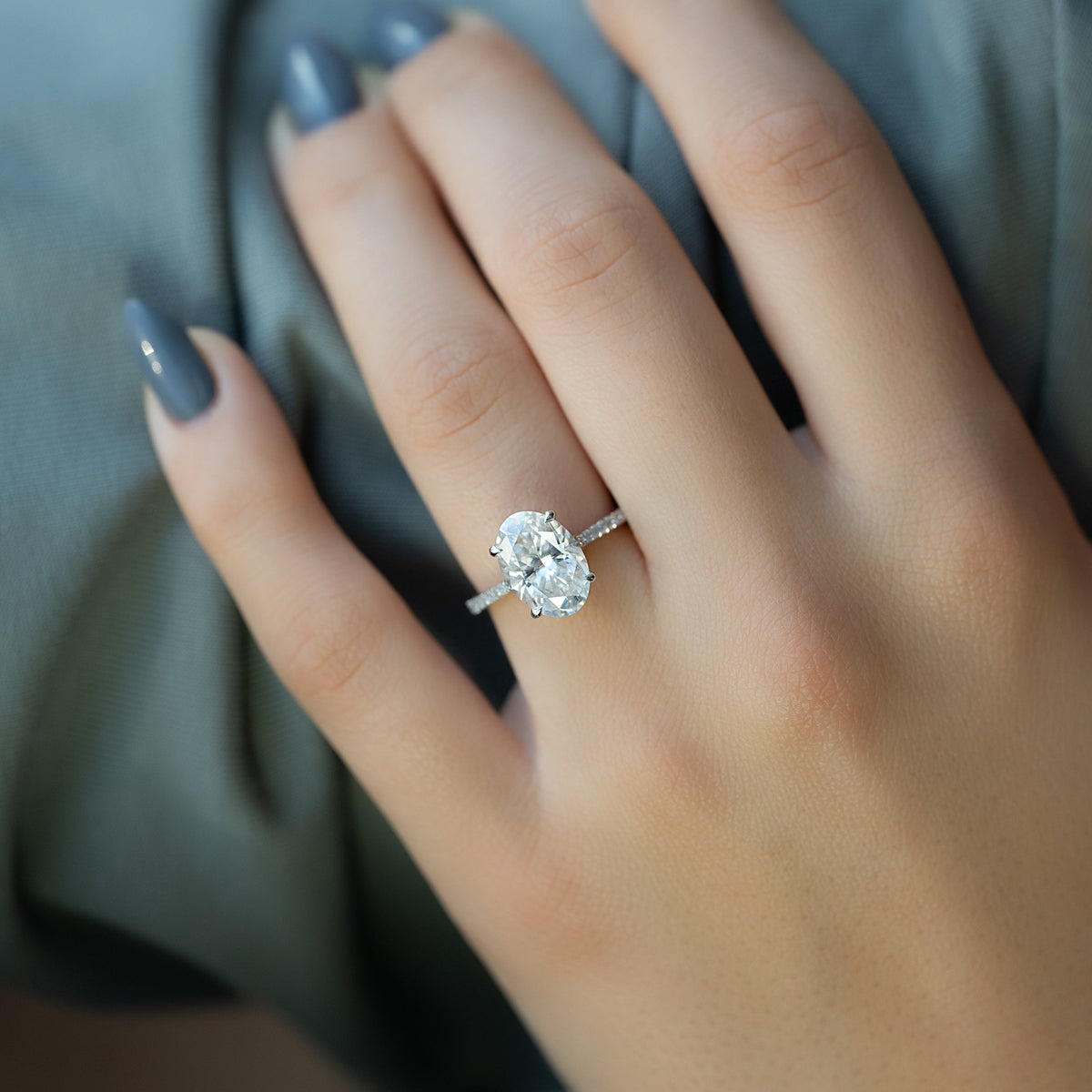 Oval cut CVD diamond engagement ring with pave diamond band in platinum setting