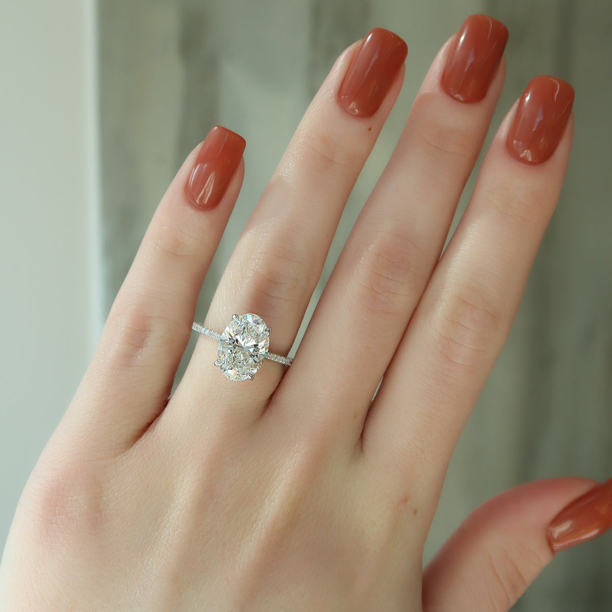 Oval cut CVD diamond engagement ring with pave diamond band in platinum setting