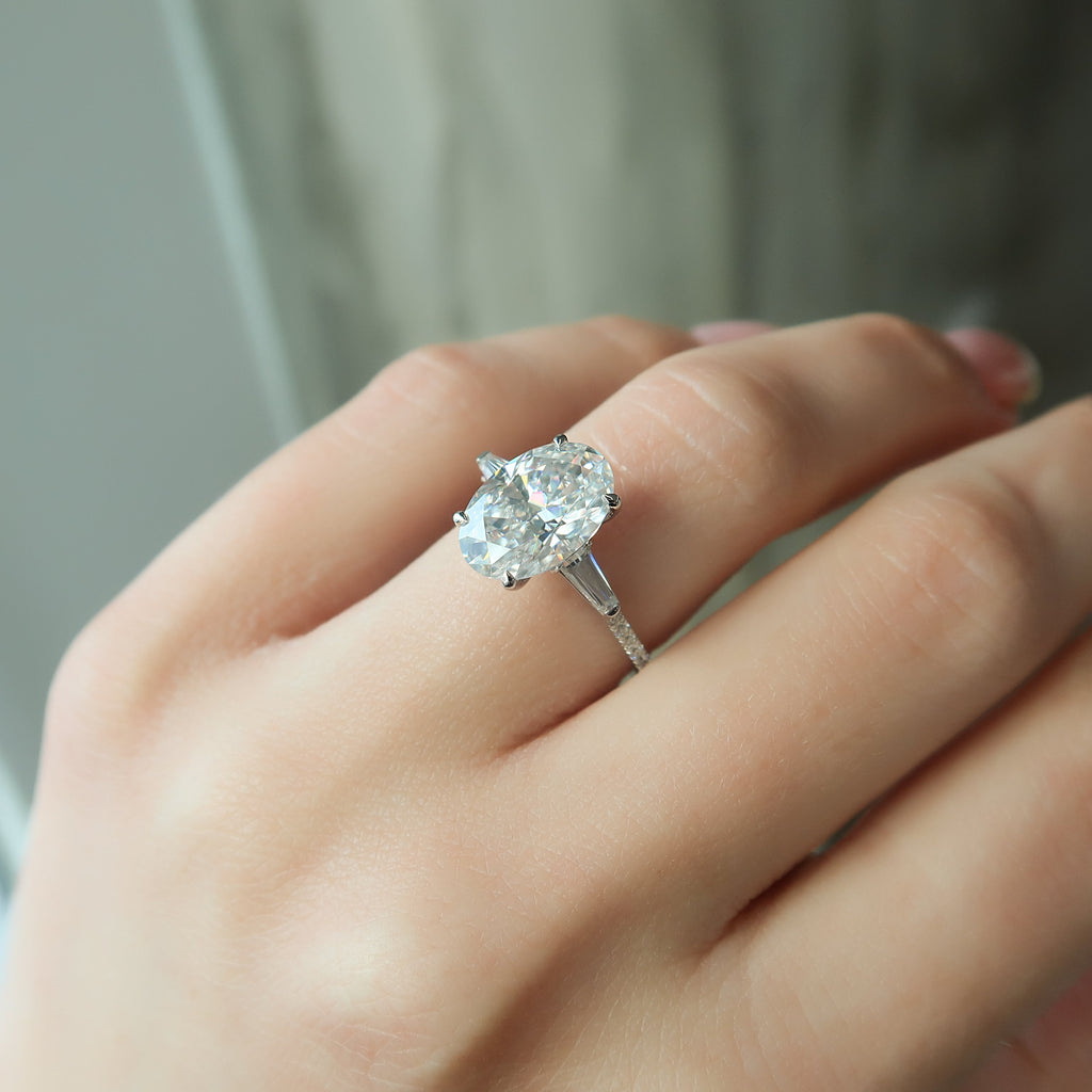 Oval cut CVD diamond three stone engagement ring with side stones in white gold