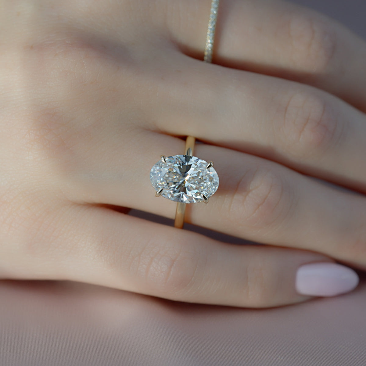 Oval cut CVD diamond hidden halo engagement ring with delicate band in white gold