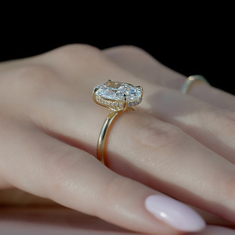 Oval cut CVD diamond hidden halo engagement ring with delicate band in white gold