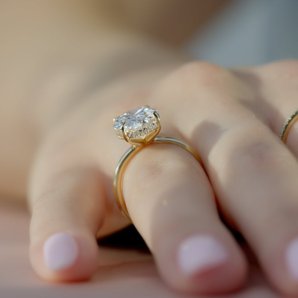 Oval cut CVD diamond hidden halo engagement ring with delicate band in white gold