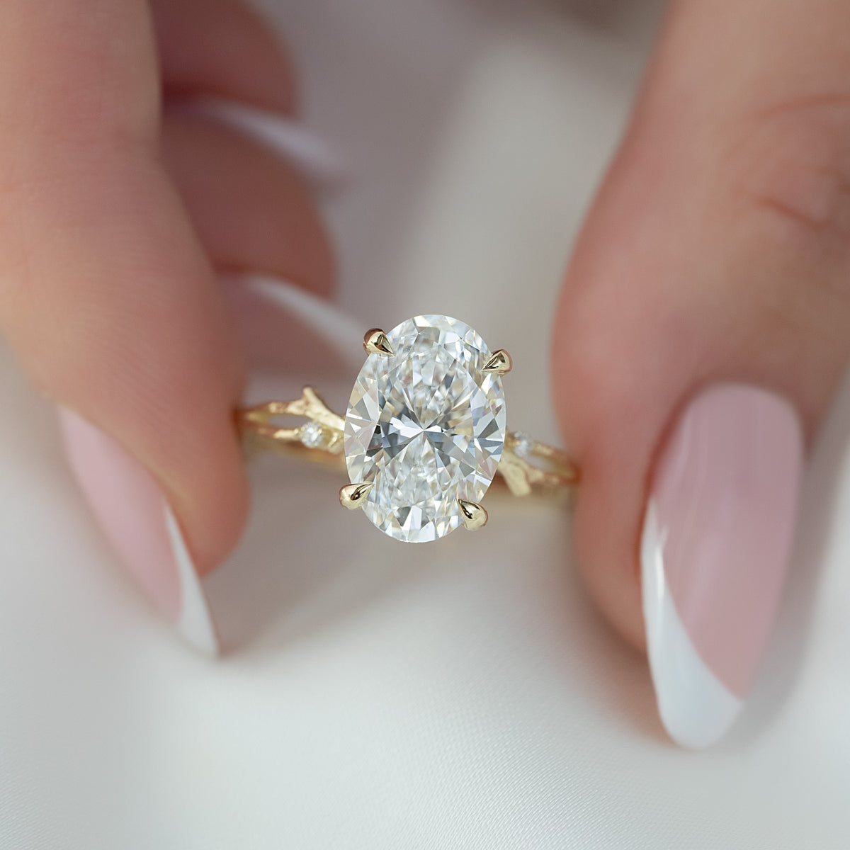 Oval cut CVD diamond engagement ring with twig-style band in white gold