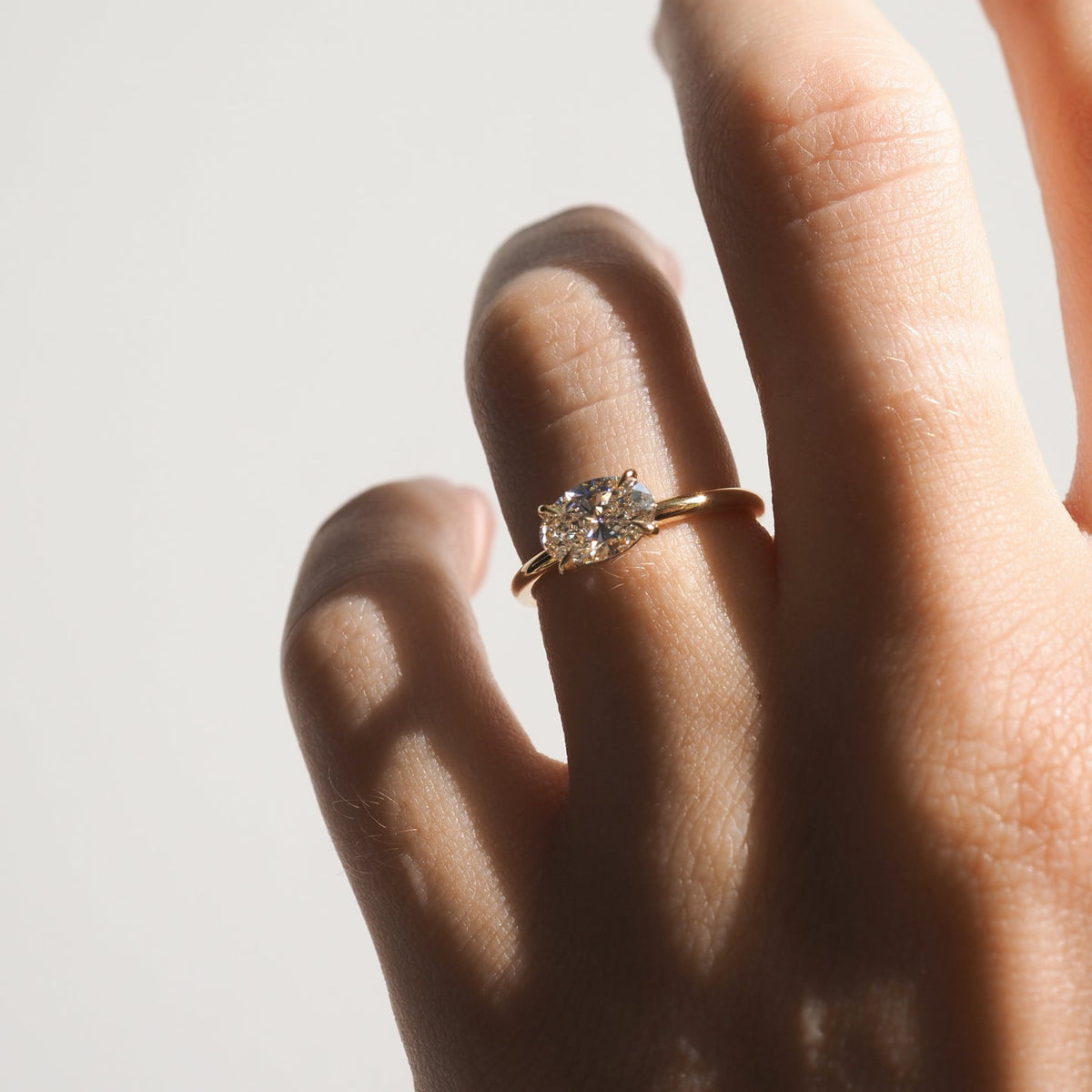 East-west elongated oval moissanite solitaire engagement ring in platinum setting, 1.0-3.0 carats