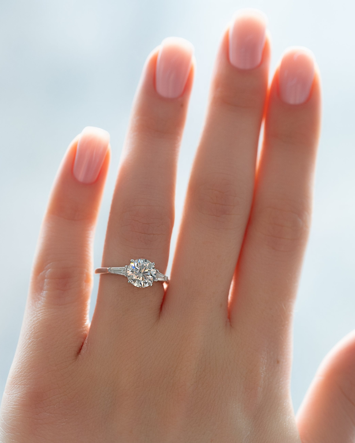 Round cut CVD diamond three stone engagement ring in platinum band