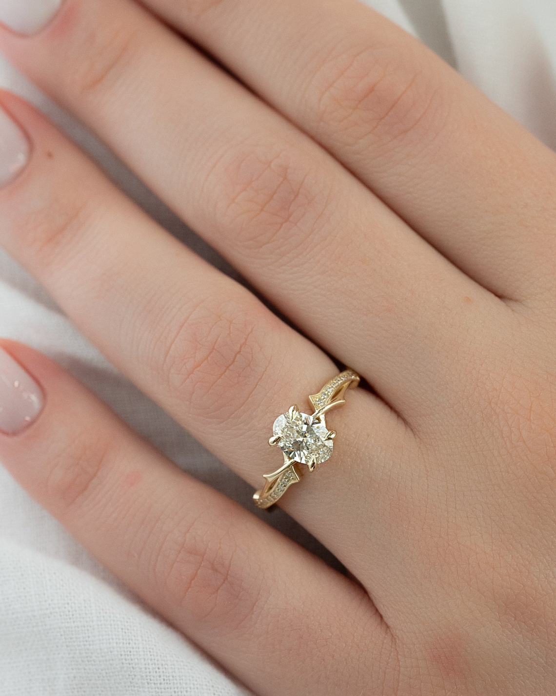 Oval cut CVD diamond engagement ring with twig-inspired band in platinum setting