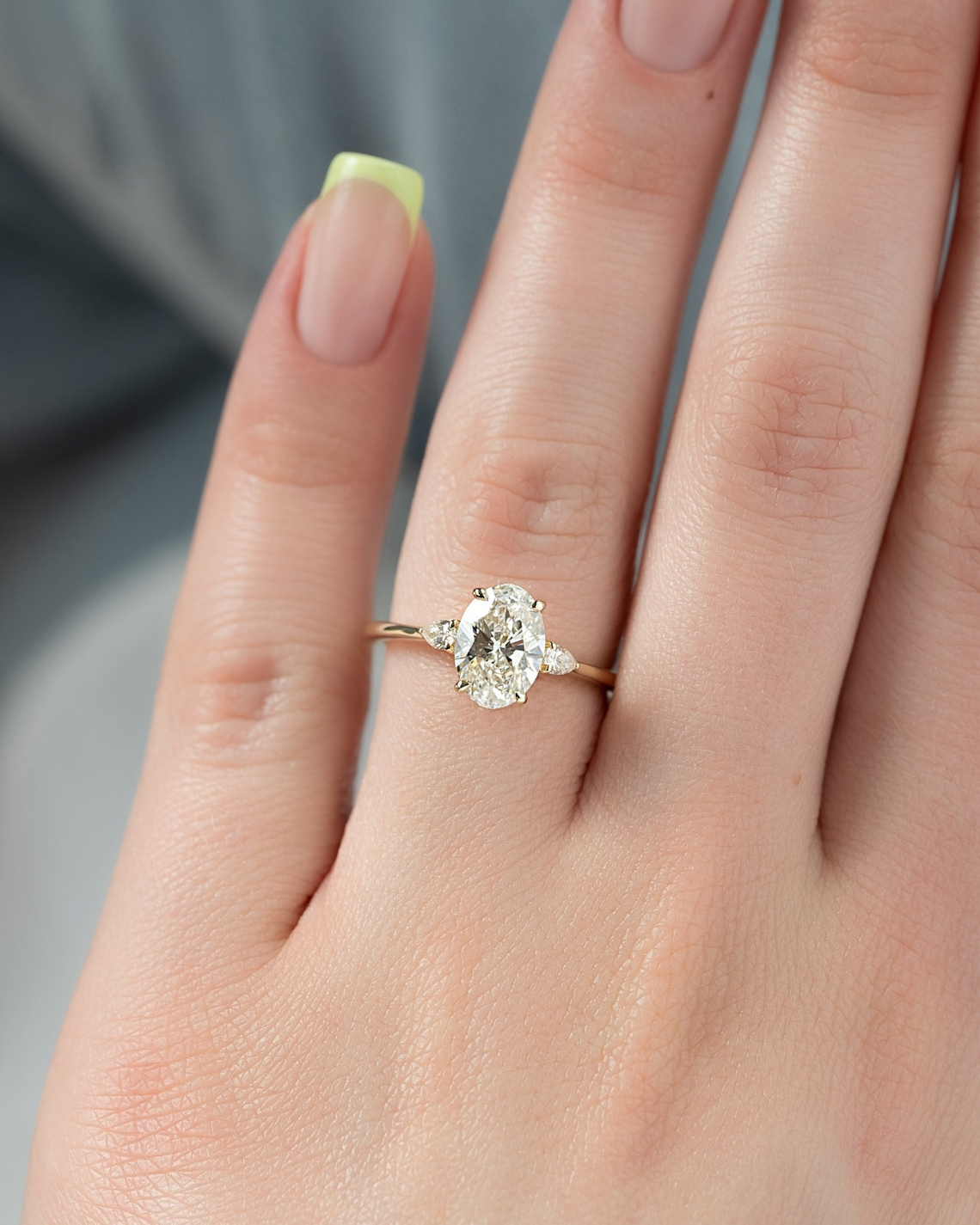 Oval cut CVD diamond three stone style engagement ring in platinum setting