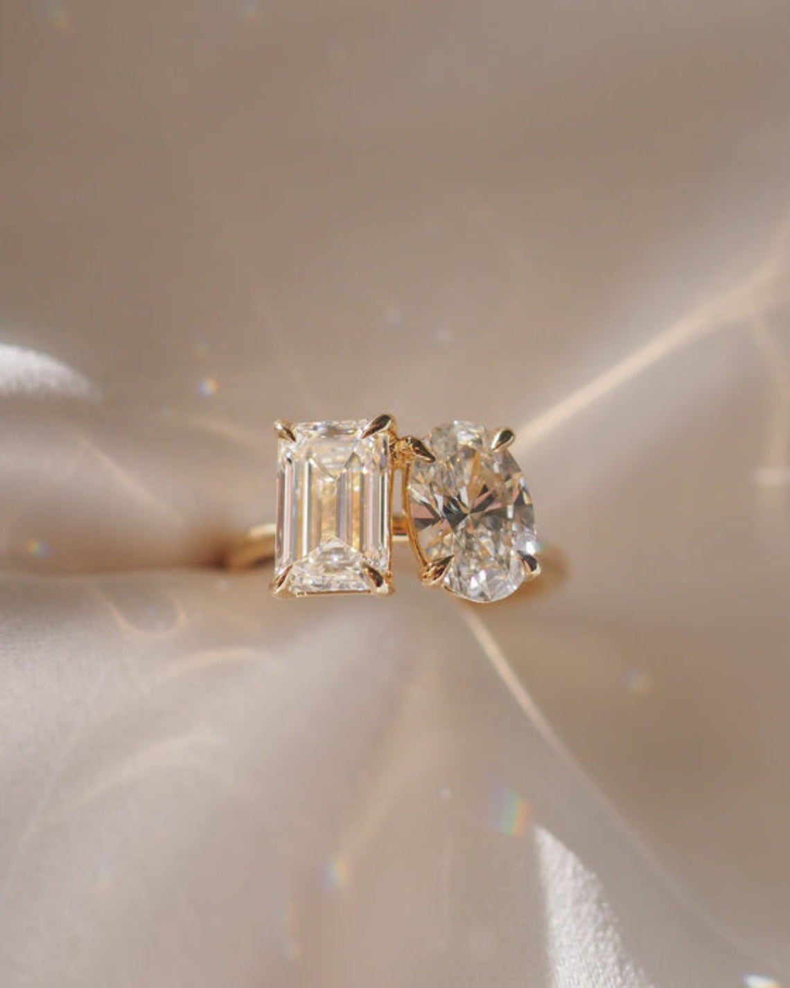 3.6 carat emerald and oval cut moissanite two-stone engagement ring in white gold setting

