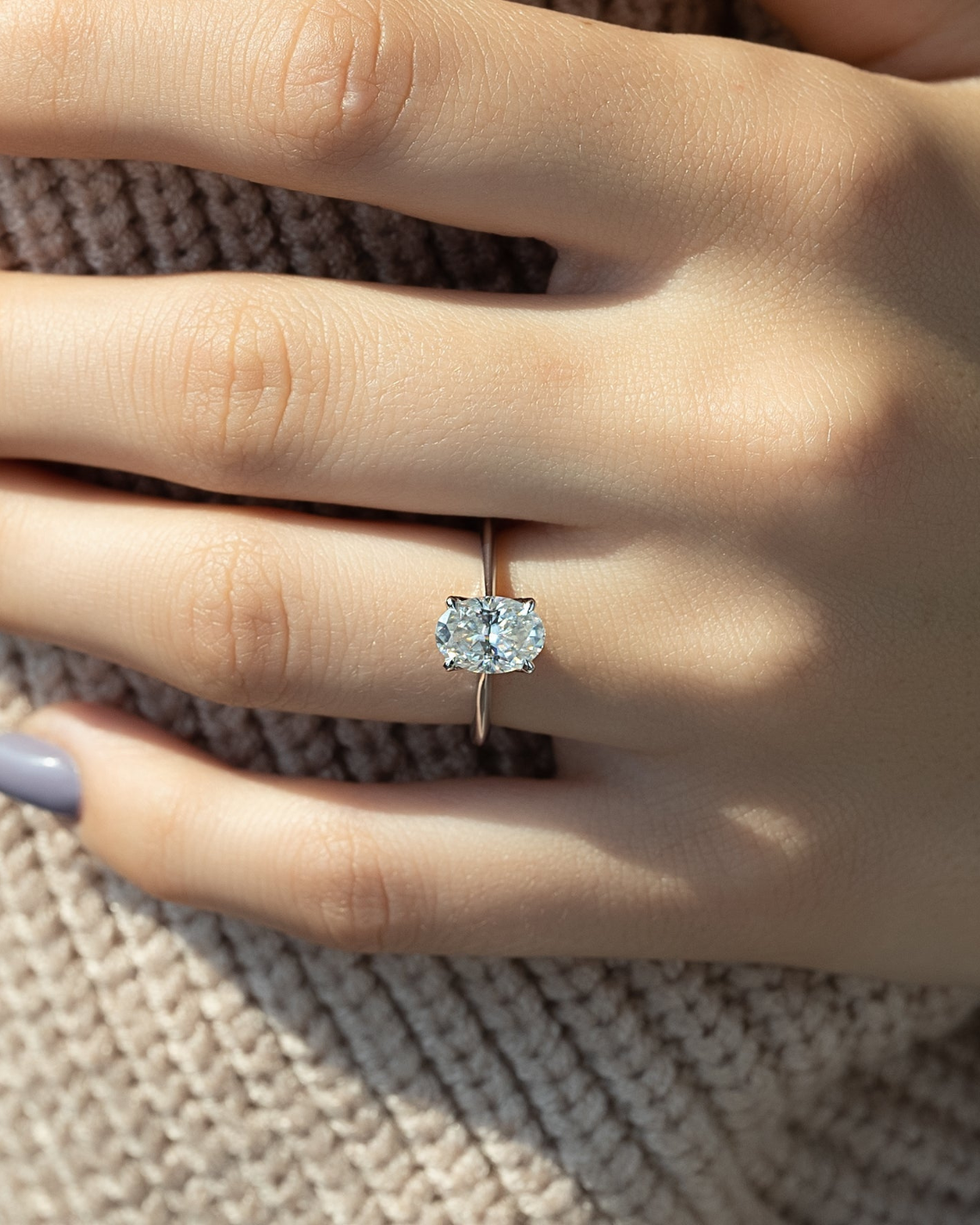 Oval cut moissanite solitaire engagement ring in platinum setting