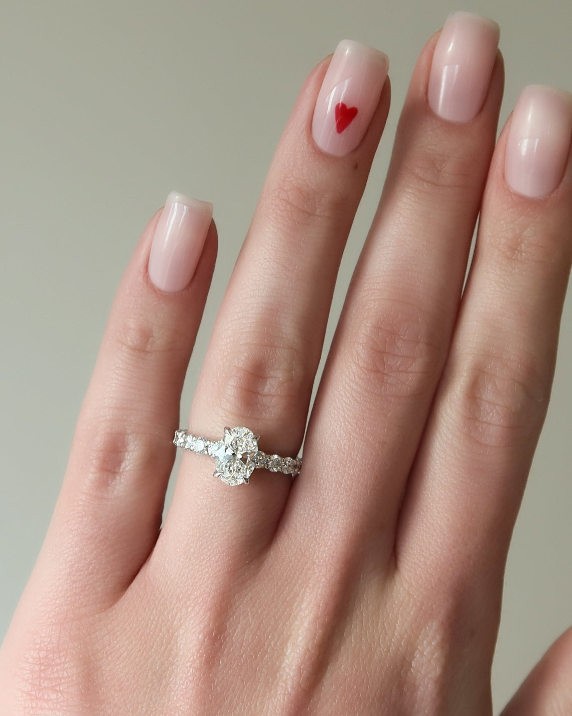 Oval cut CVD diamond hidden halo engagement ring with pave band in white gold