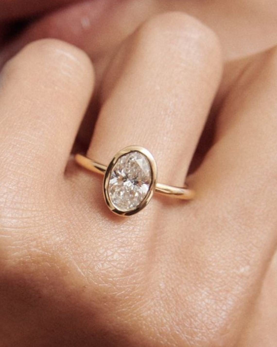 1.5–3.5 CT oval cut lab grown diamond engagement ring with bezel setting in gold, modern and minimalist bridal jewelry design

