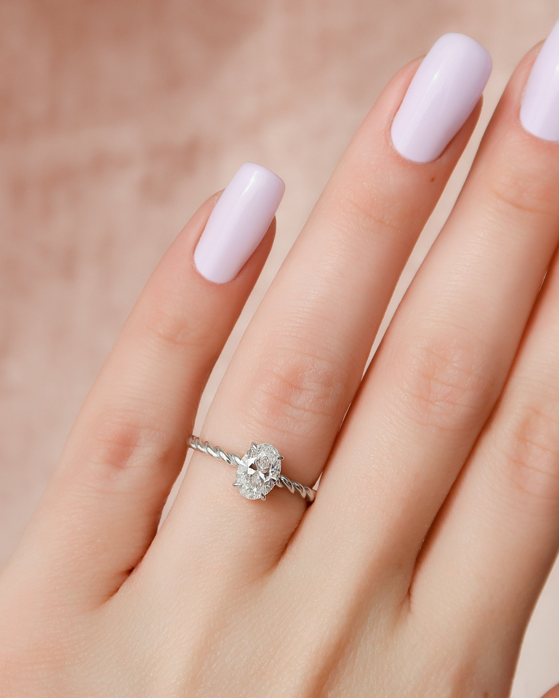 Oval cut CVD diamond engagement ring with hidden halo in platinum setting