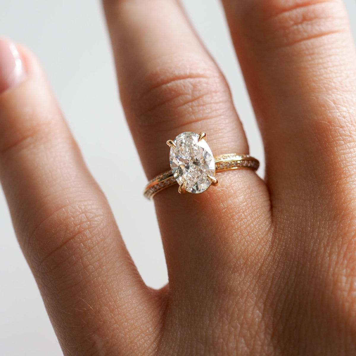 1.53 to 2.50 carat oval shaped lab-grown CVD diamond engagement ring with a shimmering pave setting in a modern elegant design


