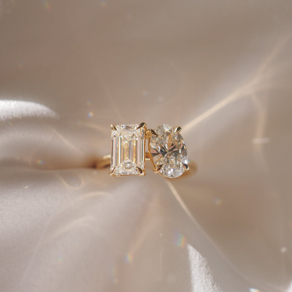 3.6 carat emerald and oval cut moissanite two-stone engagement ring in white gold setting

