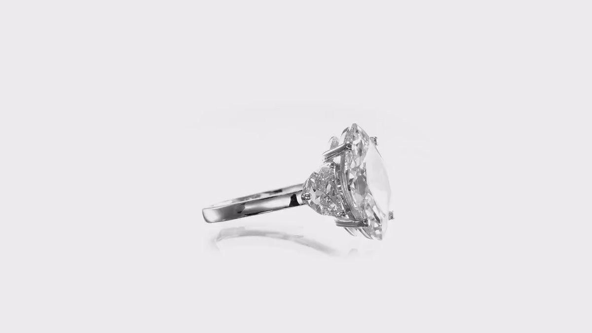 1.5–3.50 CT marquise cut lab grown diamond three-stone engagement ring with tapered side stones set in polished gold band

